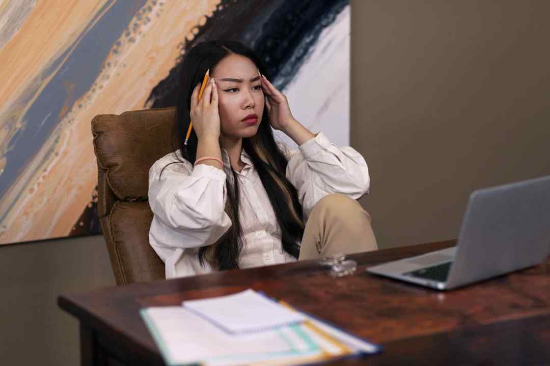 Interior designer stressed while managing multiple design projects using scattered tools before adopting IntoAEC interior design management software.