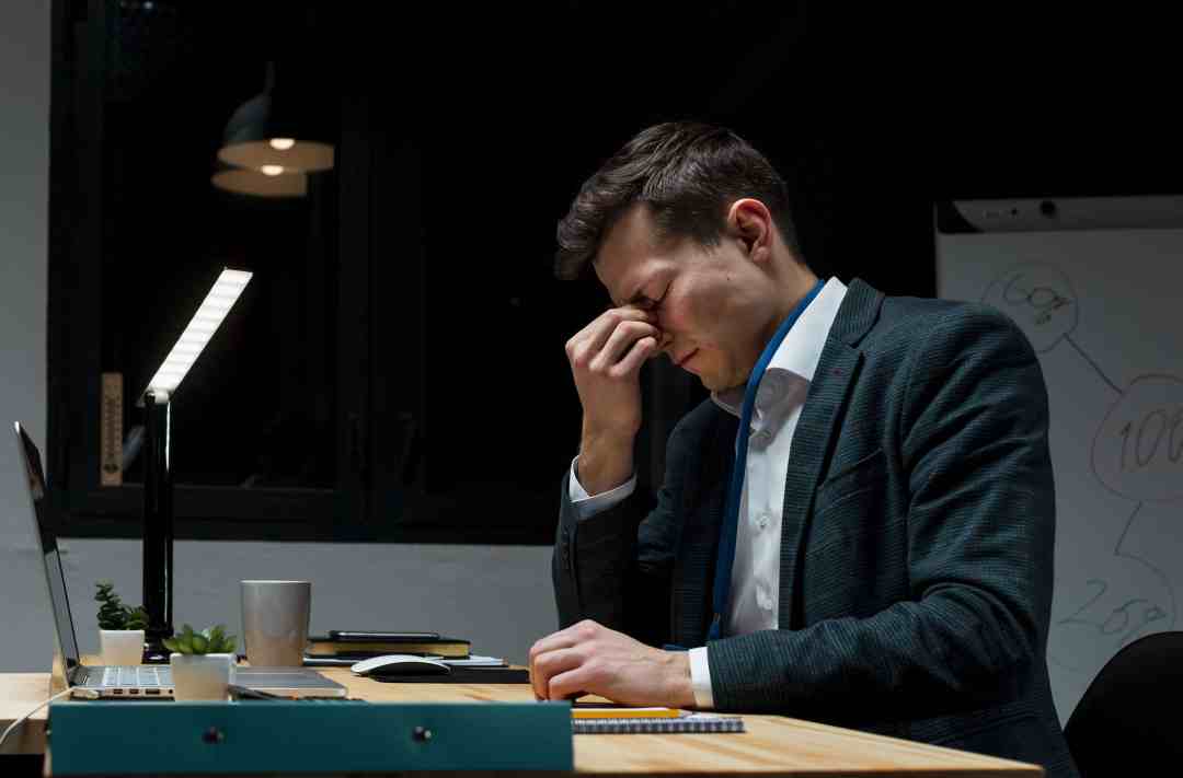 Project manager overwhelmed by fragmented systems and delayed RFIs, highlighting the need for construction project management software like IntoAEC.